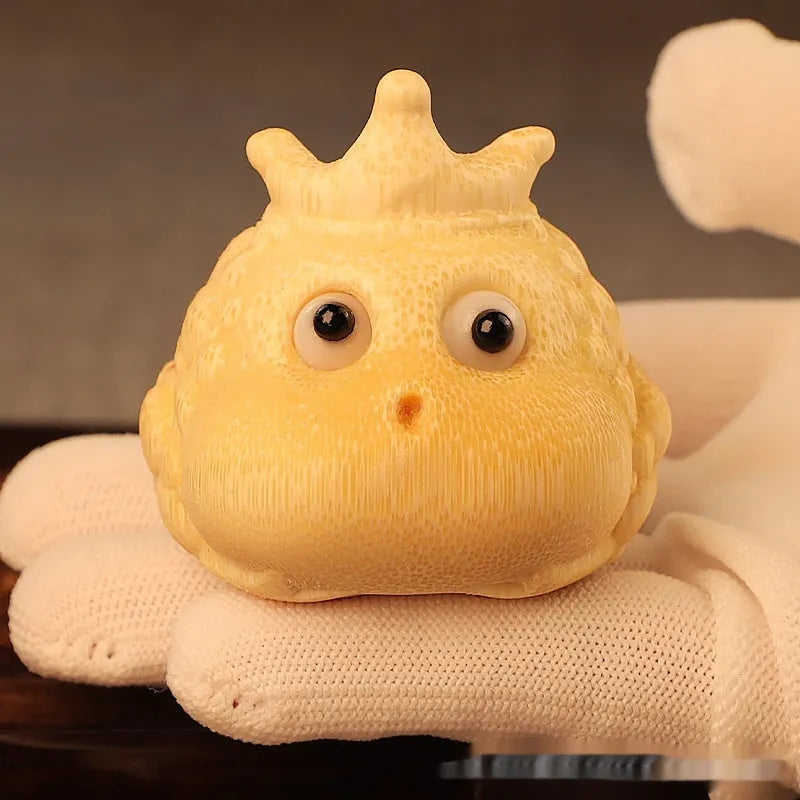Solid bamboo carving of a cute Crown Princess toad ornament on a wooden surface.