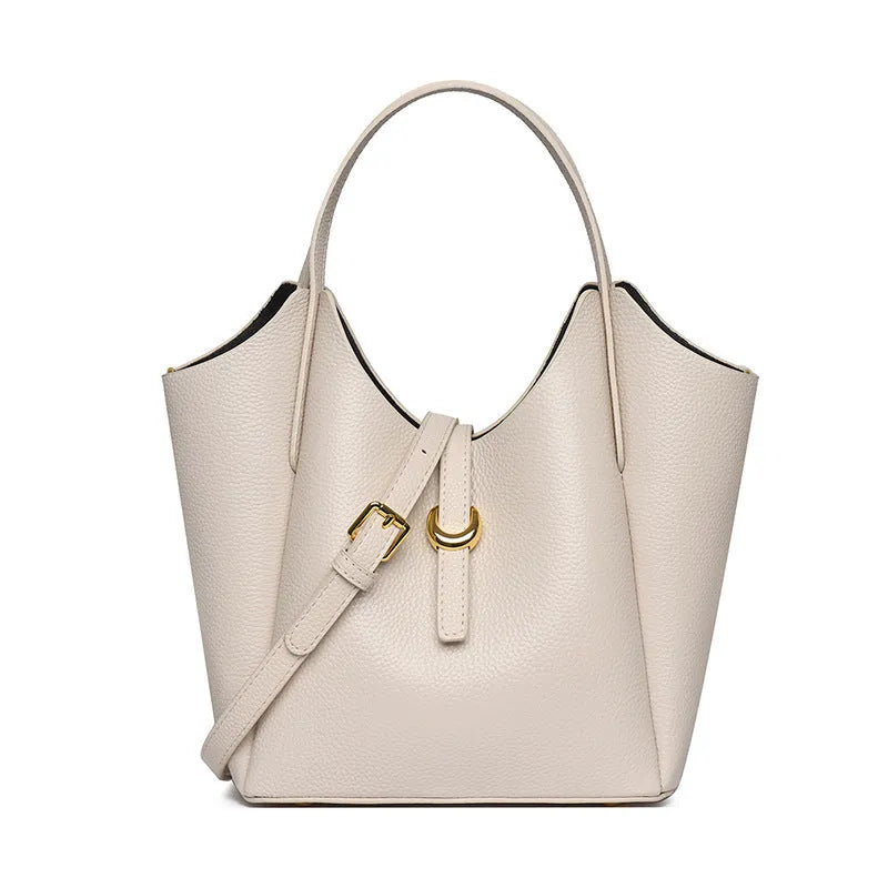 Genuine leather retro bucket handbag for women in beige, showing sewn thread detail and handheld straps.
