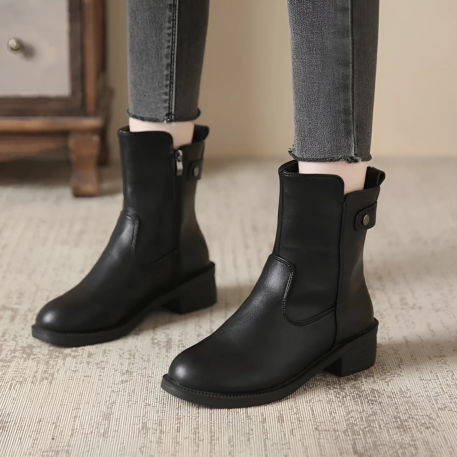 Black women's side zip boots with round toe and low rubber heel