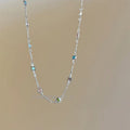 Fine geometric clavicle chain necklace with square artificial crystal links in gold or white K plating.