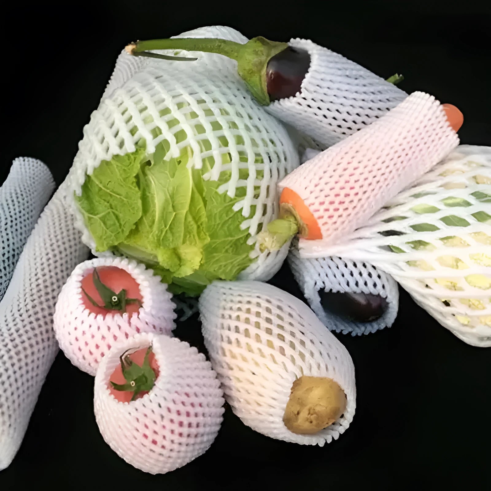 White foam protective net sleeves for fruit in assorted sizes on a table.