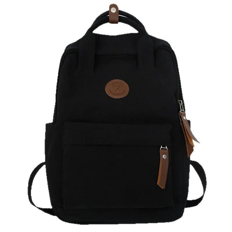 Black Oxford cloth backpack with curved shoulder straps on solid background