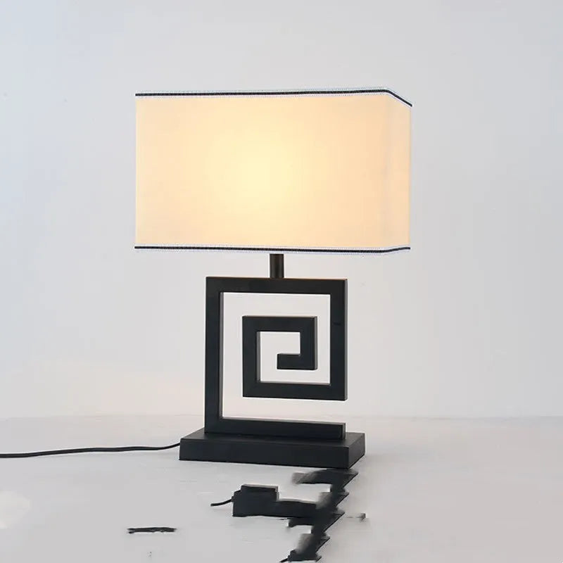 Retro modern Chinese table lamp with fabric lampshade and iron base on wooden side table