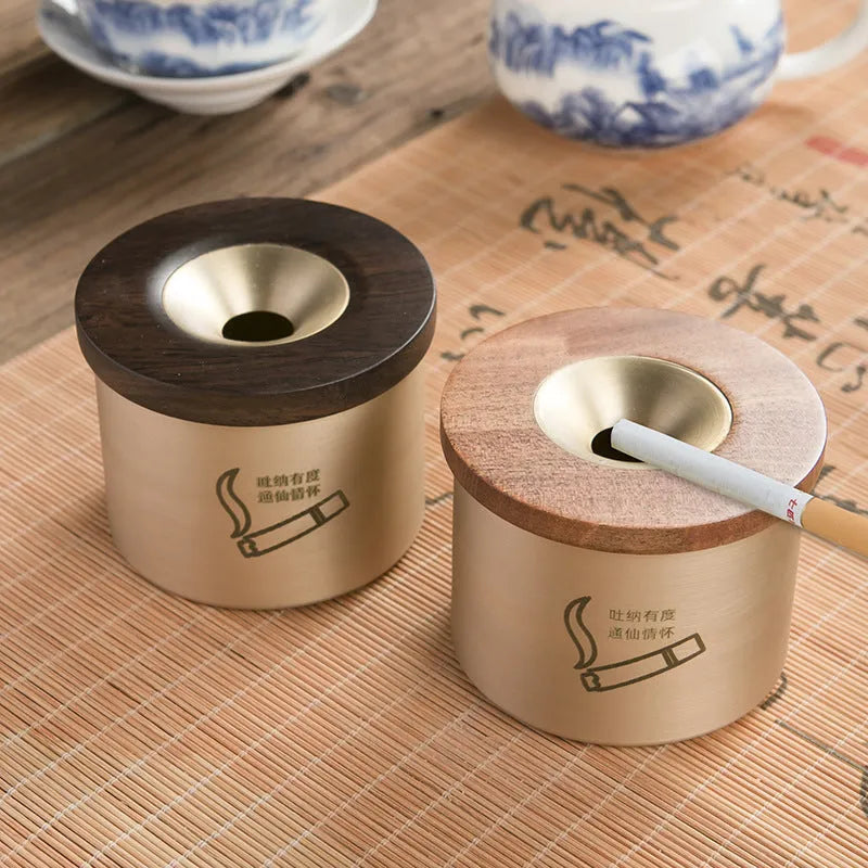 Retro brass ashtray with wooden lid showing centre hole design for ash collection