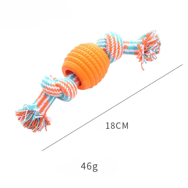 Blue silicone molar-ball dog chew toy with white rope ends on a wooden floor.
