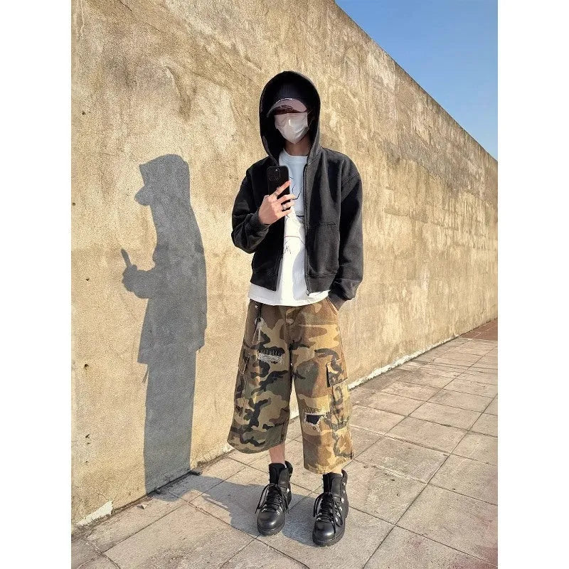 Men's loose-fit camouflage cropped jeans with ripped knee detailing, shown in a straight-leg silhouette.