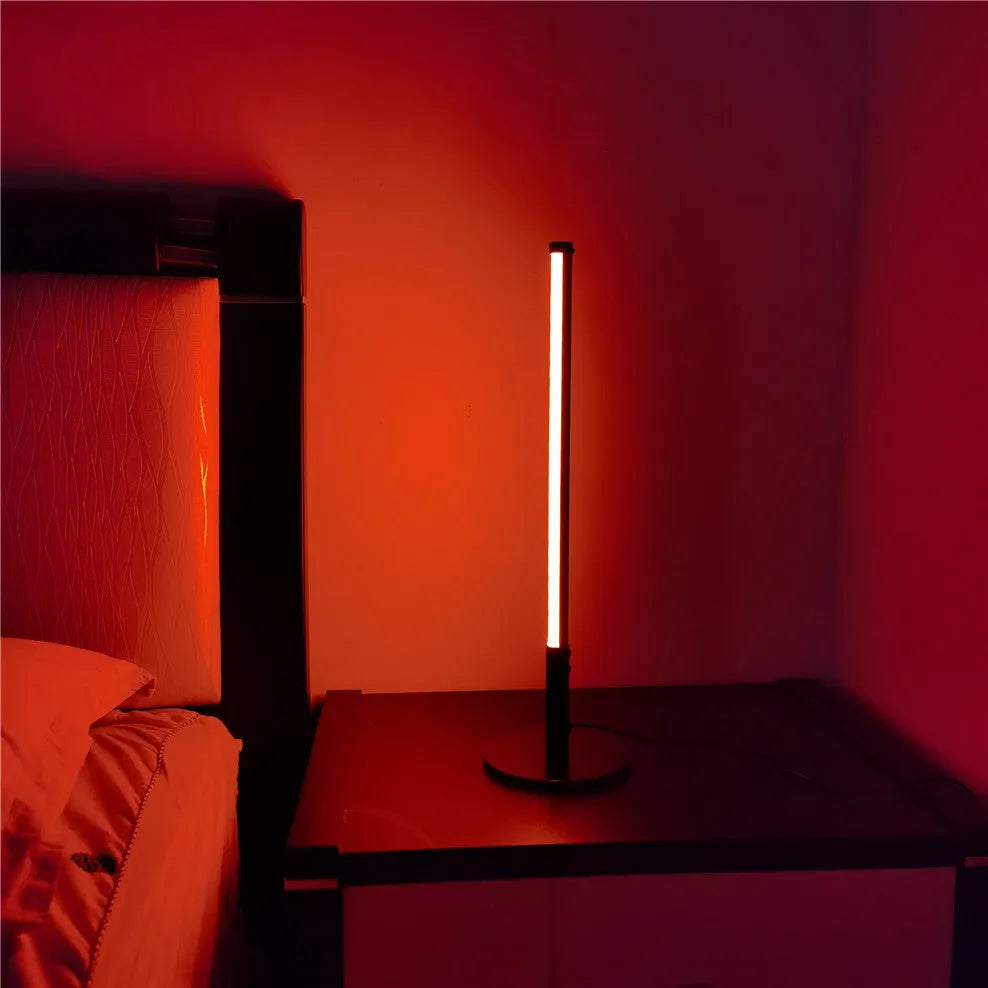 Tall, cylindrical black aluminium alloy retro atmosphere lamp on a table.