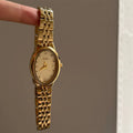 Oval dial ladies watch with dot markers, 37mm, gold strap and gold face
