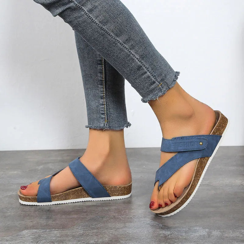 Blue flat toe ring flip-flops with a thick foam sole on a solid background.
