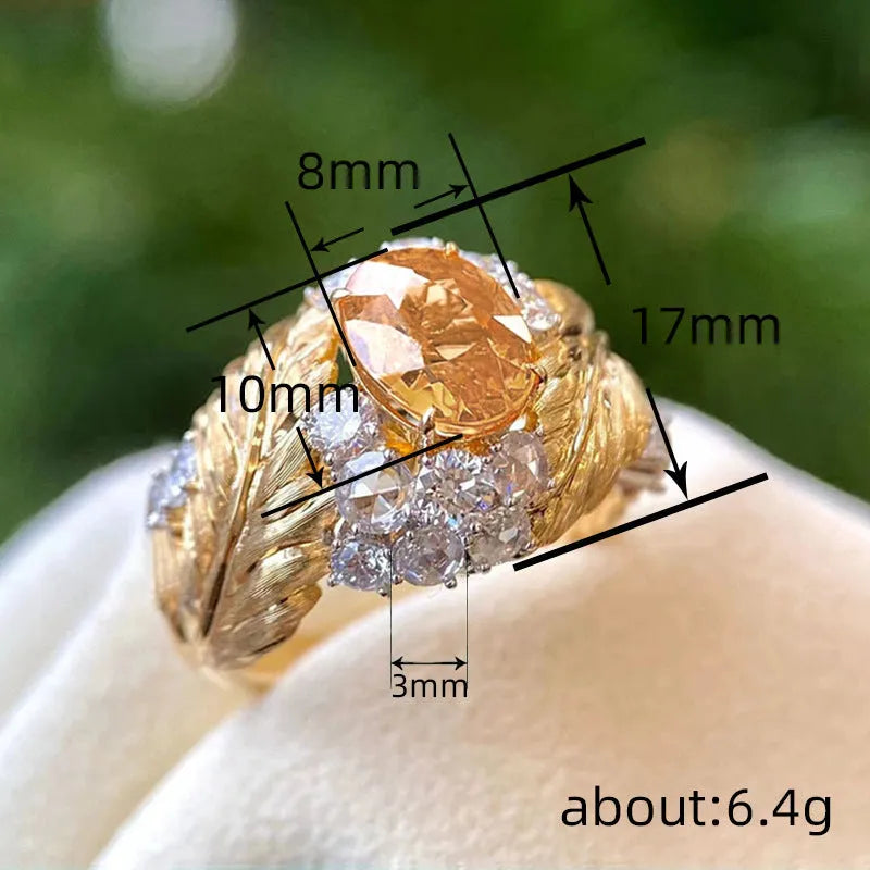 Gold-tone copper women's ring with embossed feather design and inlaid yellow zircon stones.