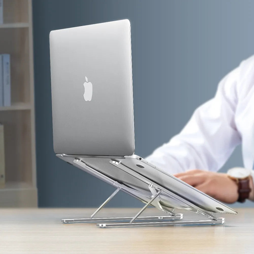 A folded and unfolded aluminium laptop stand in silver, shown next to a laptop.