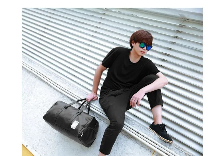 Black waterproof sports bag with diagonal straps and separate shoe compartments in two size options