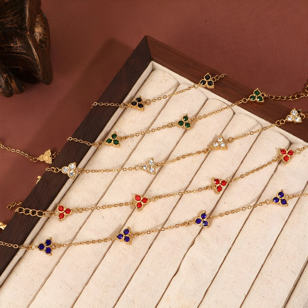 Geometric stainless steel women's bracelet with triangular links and a coloured stone centre.