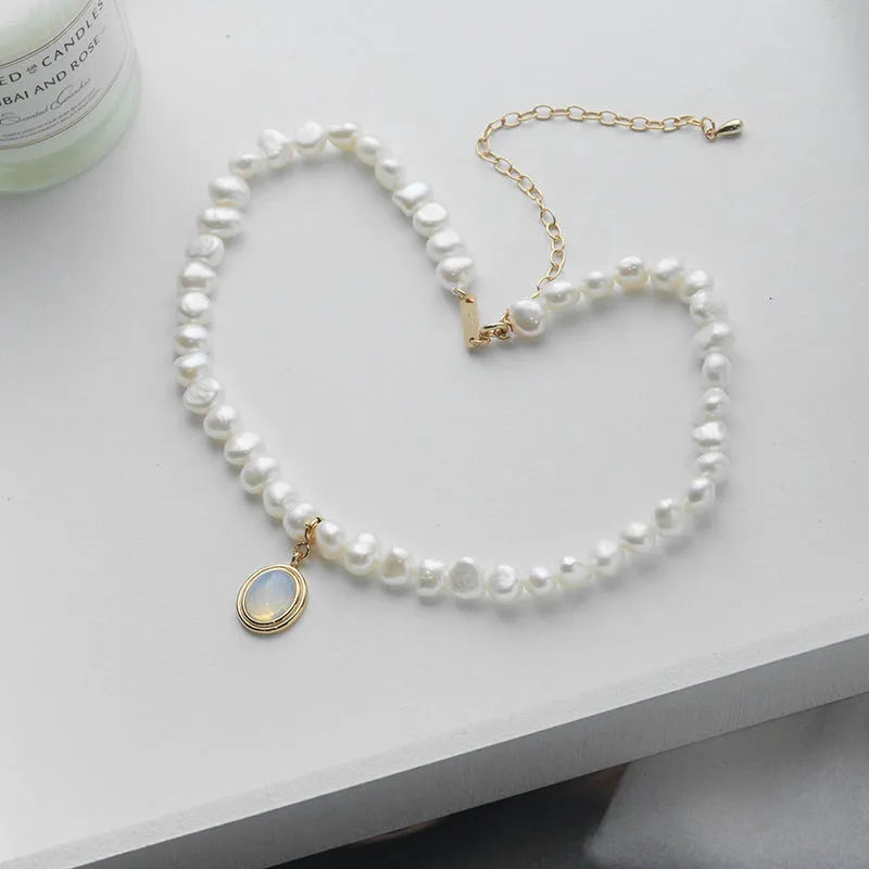 Silver necklace with round medal pendant and irregular freshwater pearls on adjustable chain