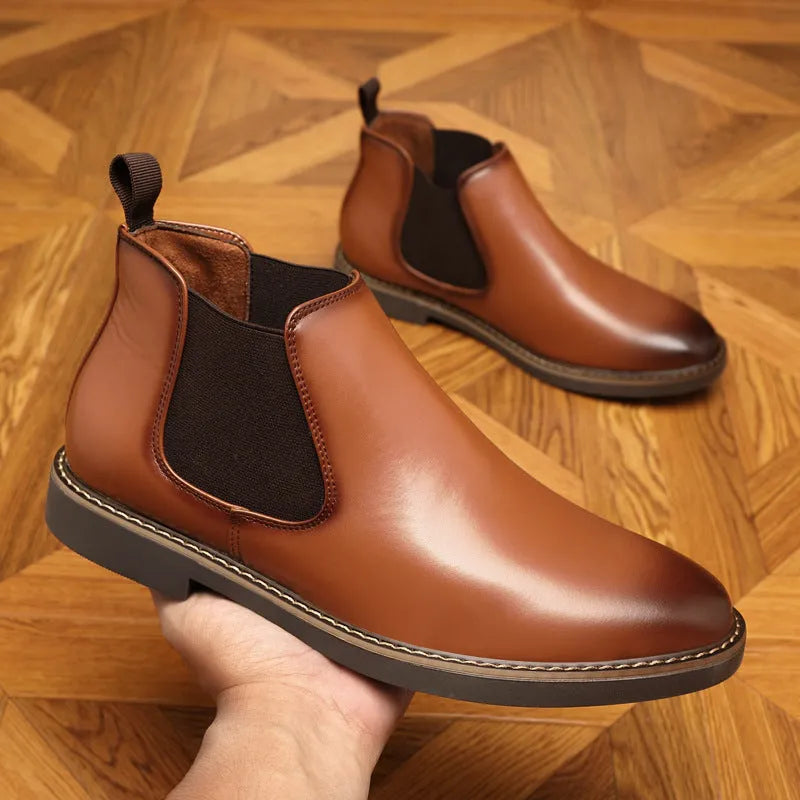Formal black pointed-toe leather boots with a square heel and rubber sole on a plain background.