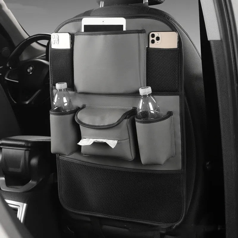 Leather car seat back storage bag in black, hanging behind a car headrest.