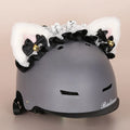 Colourful plush cartoon hat decoration sitting on top of a ski helmet