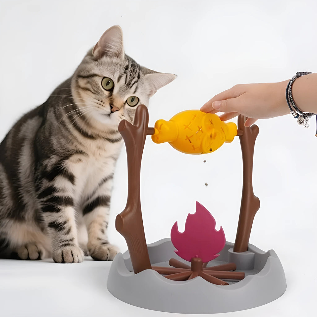 Blue and white tumbling cat food feeder toy on a wooden floor