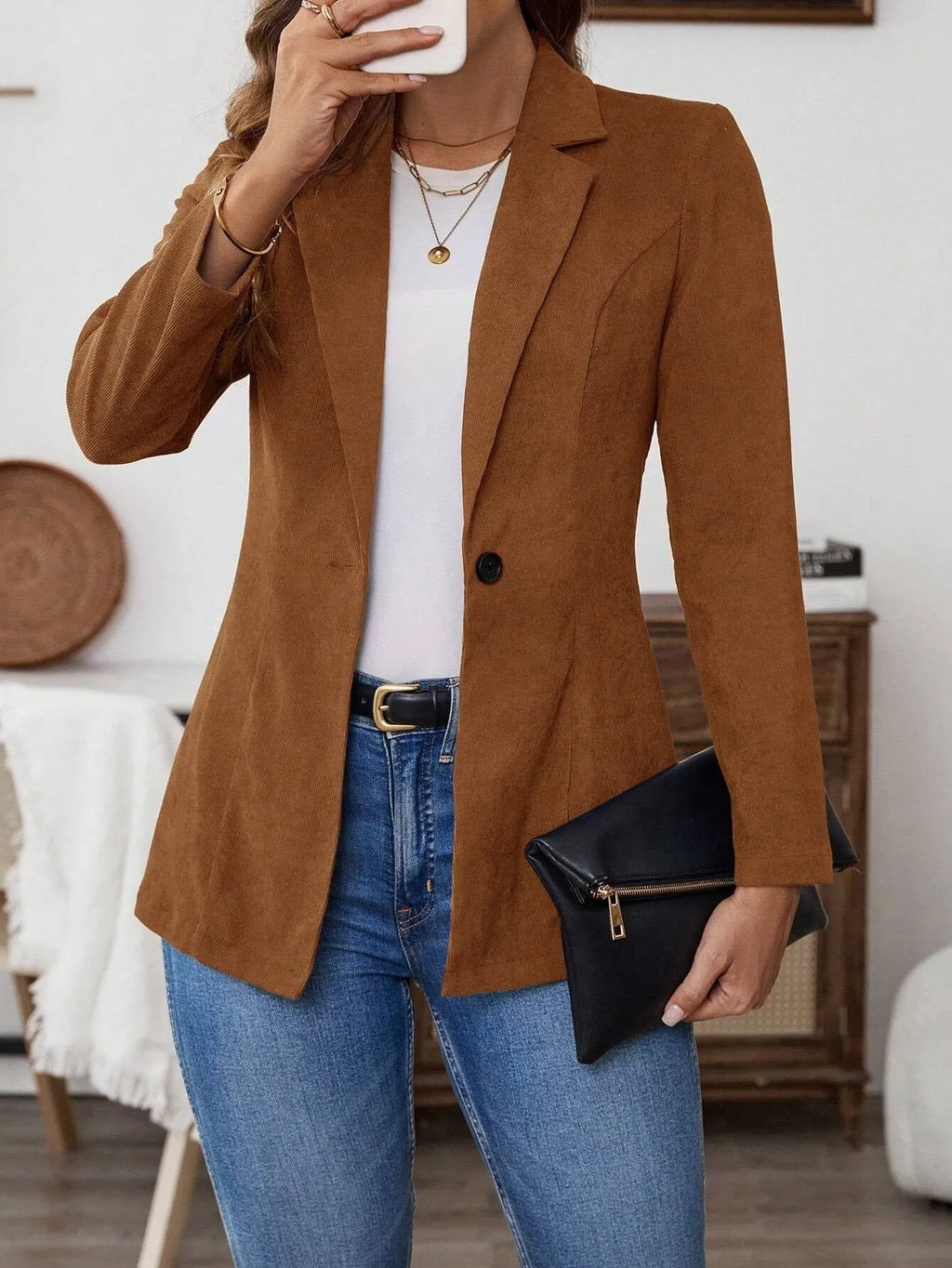 Brown men's lapel long sleeve single-breasted suit coat on a hanger