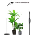 White retractable floor plant grow light with circular LED head extended on a pole.