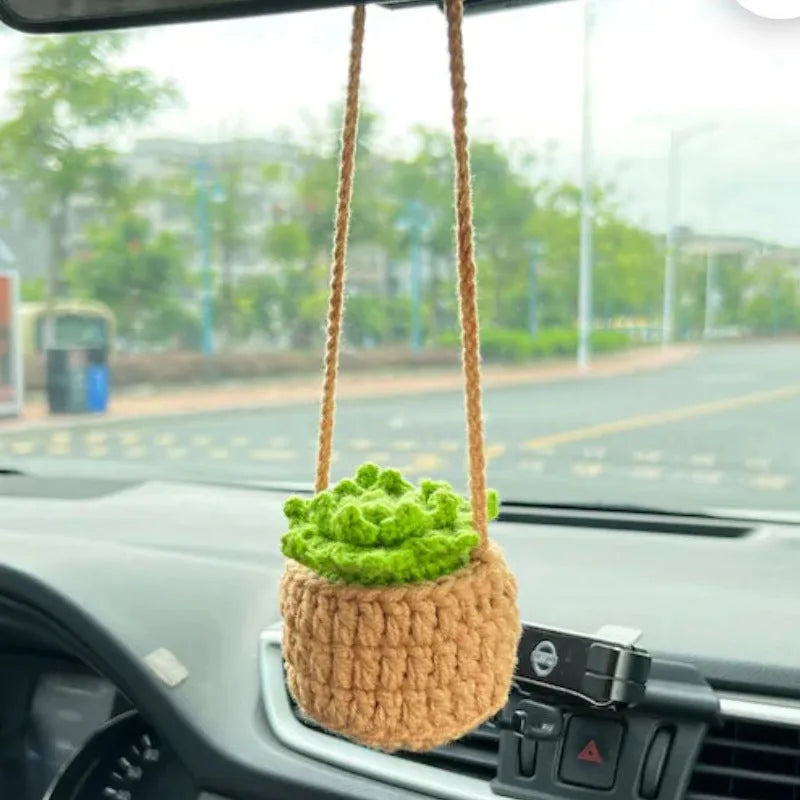 Green and white fish-scale style knitted wool car hanging planter with 8cm base and long white cord.