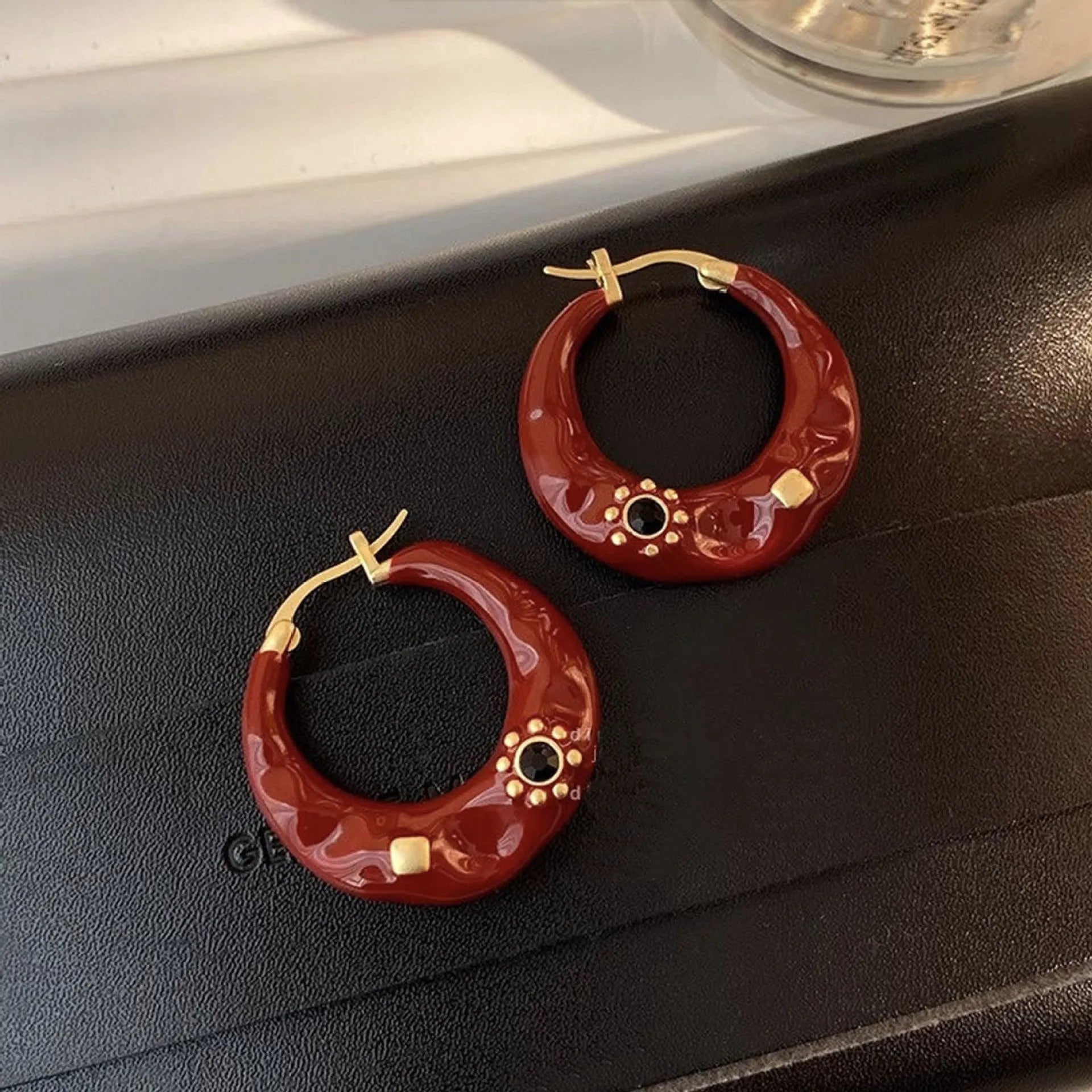 Retro alloy ear studs with dripping oil texture and rhinestone decorations in black or red colours