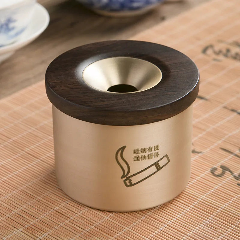Retro brass ashtray with wooden lid showing centre hole design for ash collection