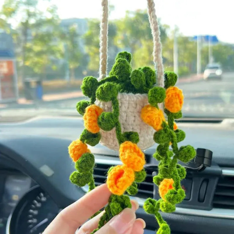 Green and white fish-scale style knitted wool car hanging planter with 8cm base and long white cord.