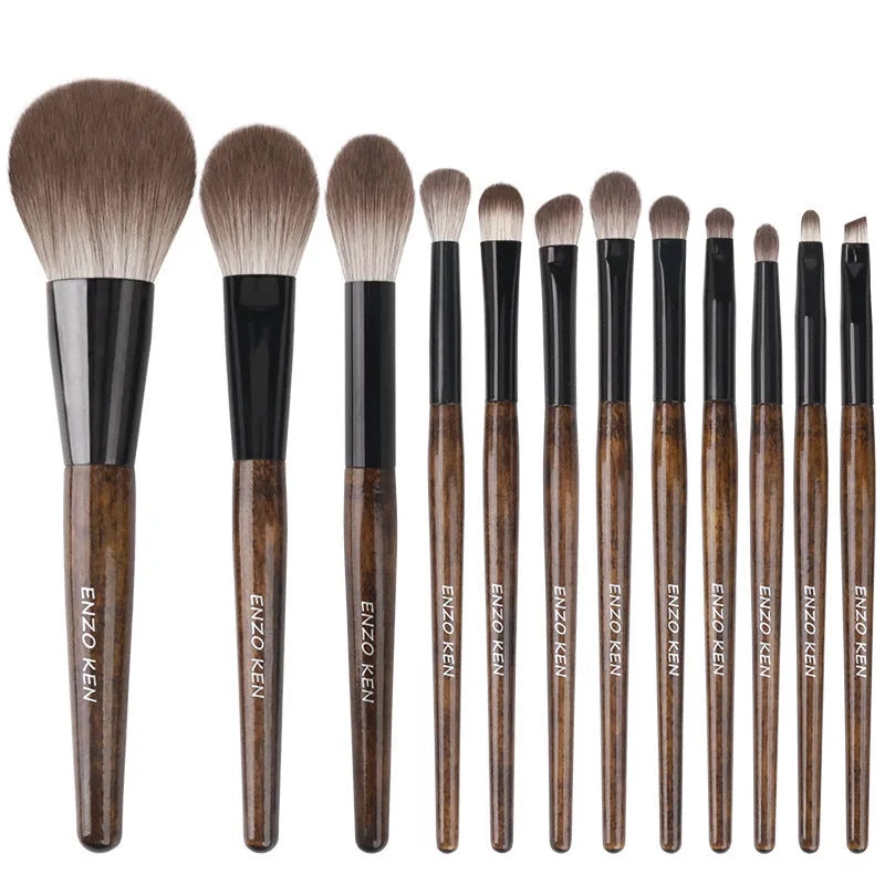 12-piece makeup brush set with wooden handles and a grey PU storage bag