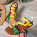 Women's brown flat sandals with Velcro fastening and rubber sole on a white background.