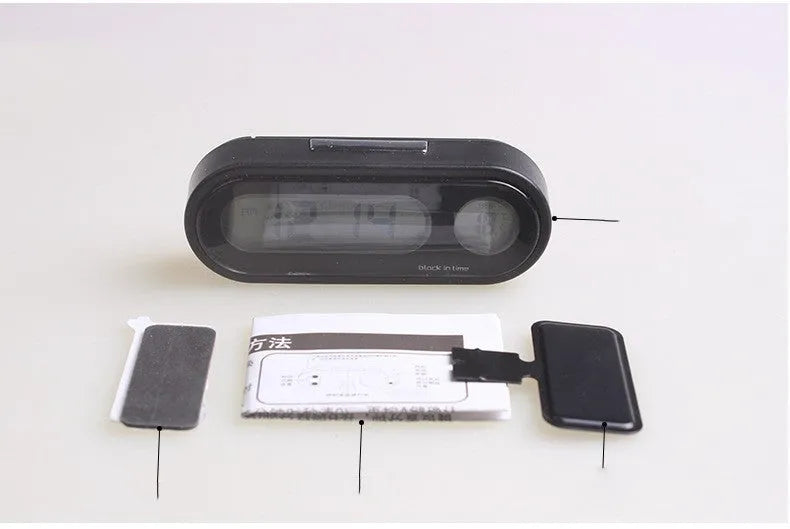 Black car digital clock thermometer with luminous display on adjustable bracket showing time and temperature
