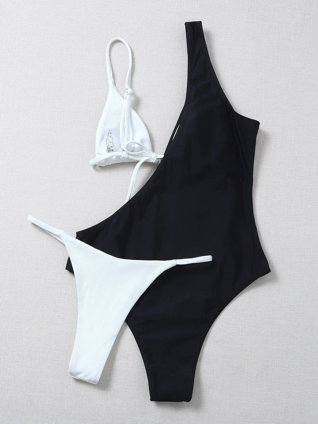 Solid colour bikini with chest pad in black and white, polyester fabric, front view