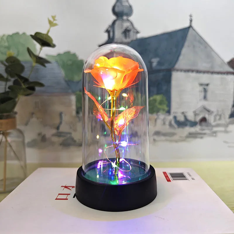 Glass cover small night lamp with plastic flowers in 15cm tall design with black base