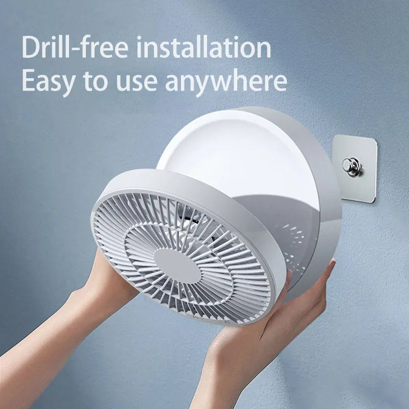 White portable rechargeable folding fan with remote control and warm night light on a desk