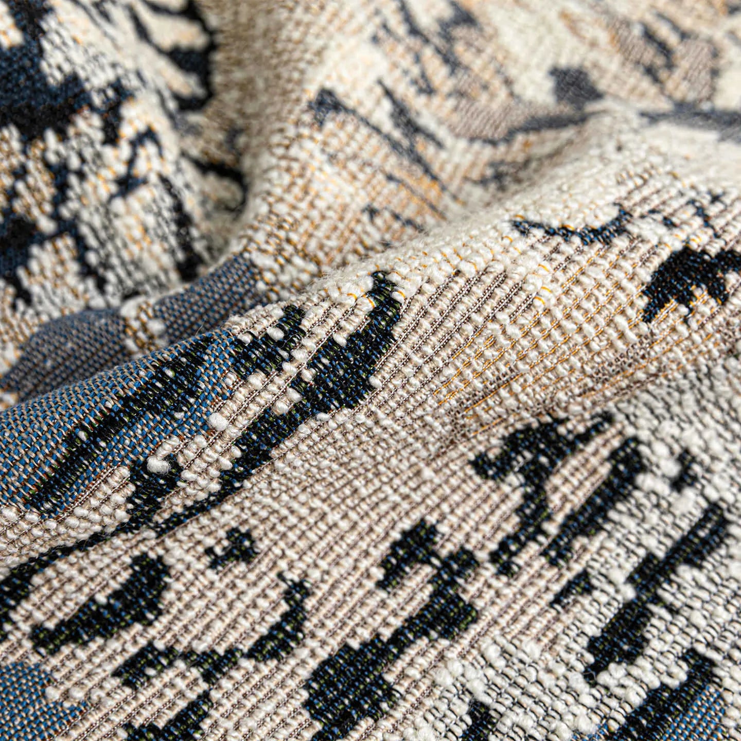 Antique blue cushion with embroidered floral pattern in Chinese style on a sofa