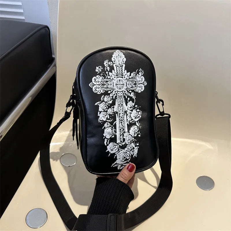 Black mini crossbody bag with Halloween cartoon print of pumpkins, ghosts, and bats.
