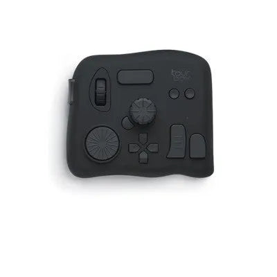 TourBox NEO black USB video editing controller auxiliary keyboard on a desk.