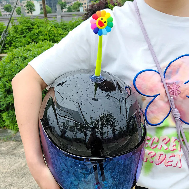 Yellow silicone sunflower decoration with a suction cup base for helmet mounting.
