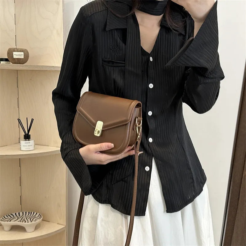 Soft PU leather clamshell messenger bag in a horizontal square shape on a shoulder strap.