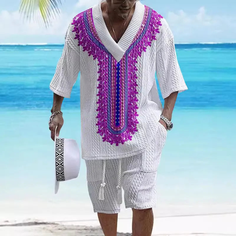 Man wearing a printed drop-shoulder knitted short-sleeve top and matching shorts in a casual setting.