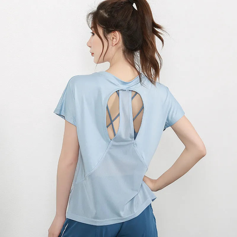 Women's pink polyester short sleeve sports T-shirt for running and fitness.