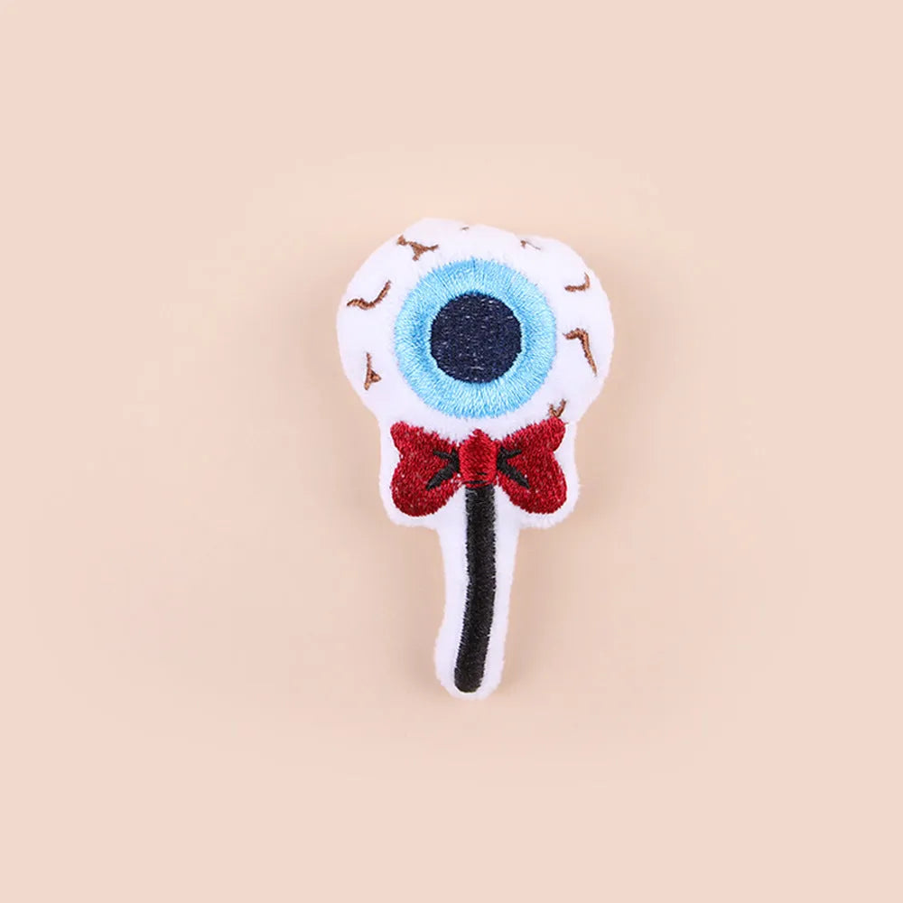 Small plush cat teaser wand with candy and skull designs for indoor play
