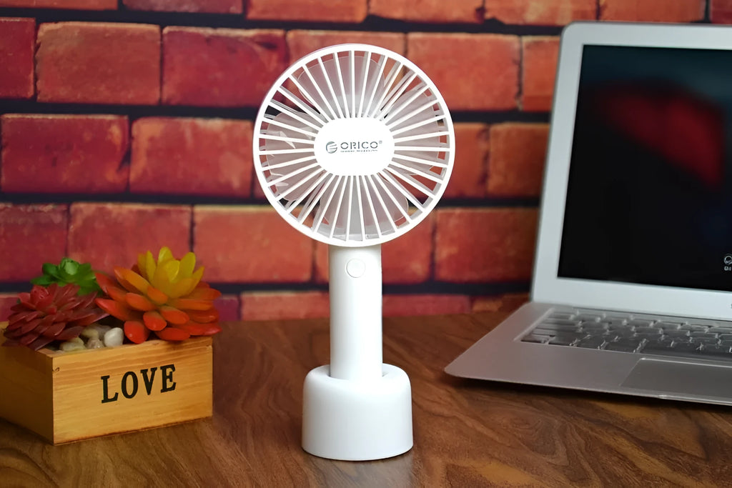 White ORICO FH1 portable USB rechargeable desk fan with fine-line texture on a desktop