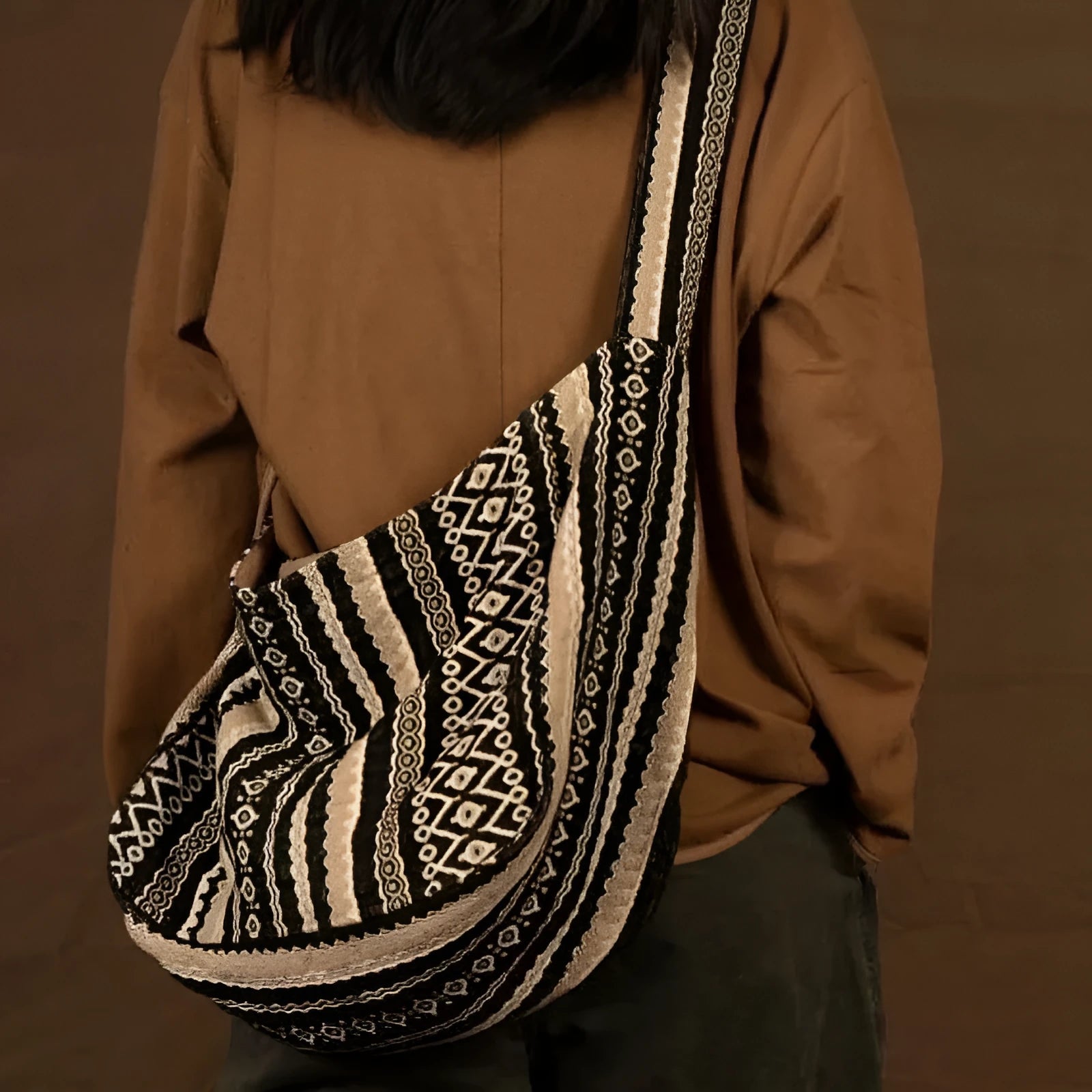 Retro striped corduroy messenger bag with jacquard detail and an adjustable plaid shoulder strap.