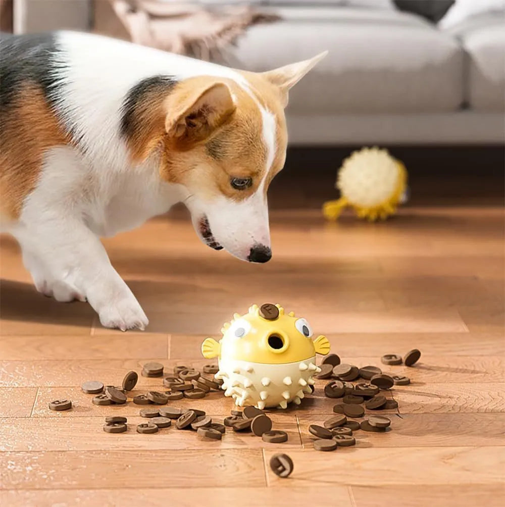 Green fish-shaped interactive dog toy with treat dispensing opening and textured surface for dental cleaning