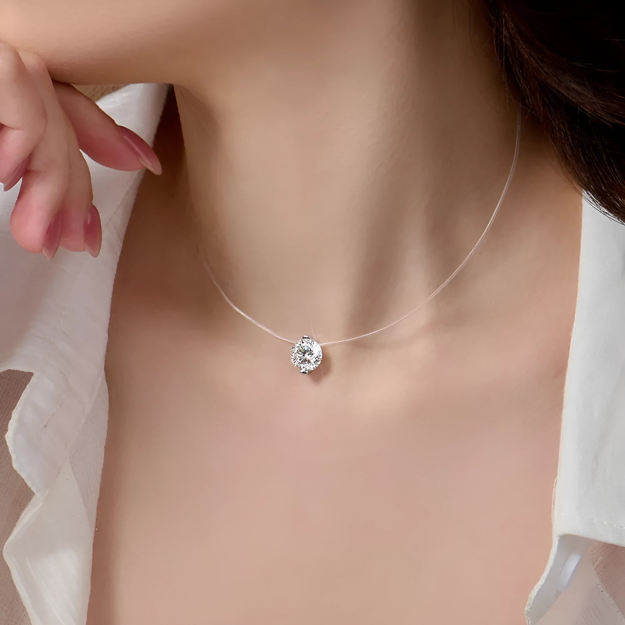 Close-up of a women's S925 silver moissanite pendant necklace on an invisible fishing line chain.