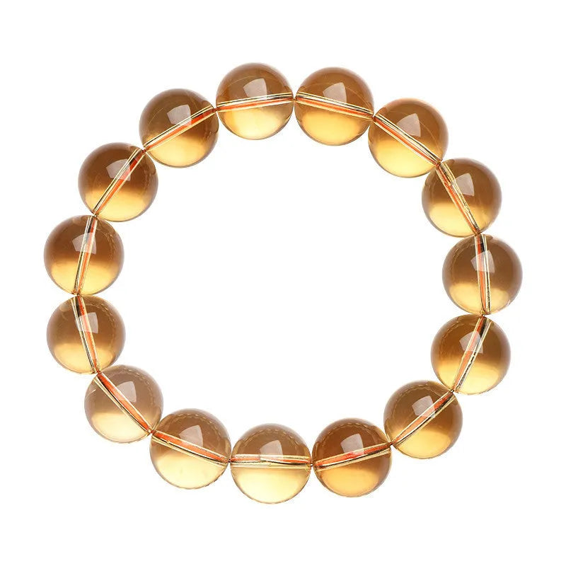 Natural citrine scattered beads ball bracelet showing polished yellow stone beads on wrist.