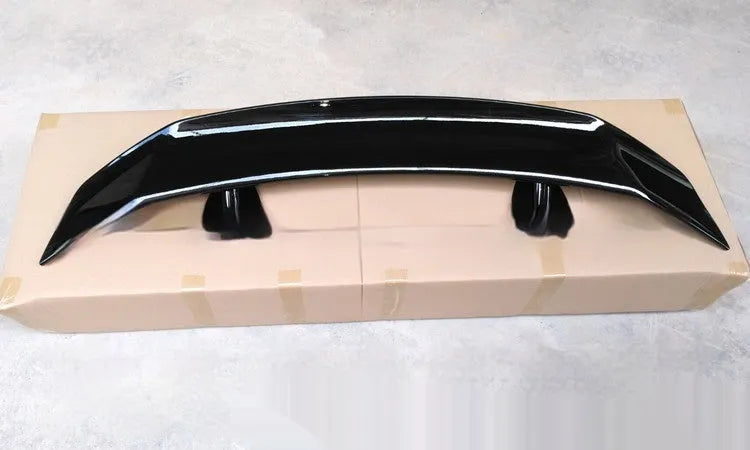 Universal punch-free car spoiler in ABS plastic showing blank, black, white, and carbon pattern finish options.