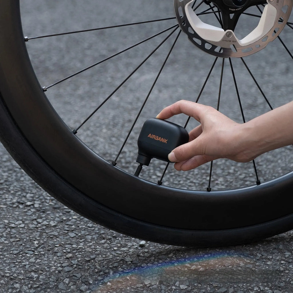 Black AS100 mini electric bicycle inflation pump with USB charging cable
