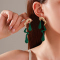 Liquid irregular geometric ear studs in gold, made from zinc alloy with electroplated finish, unique water drop design for women